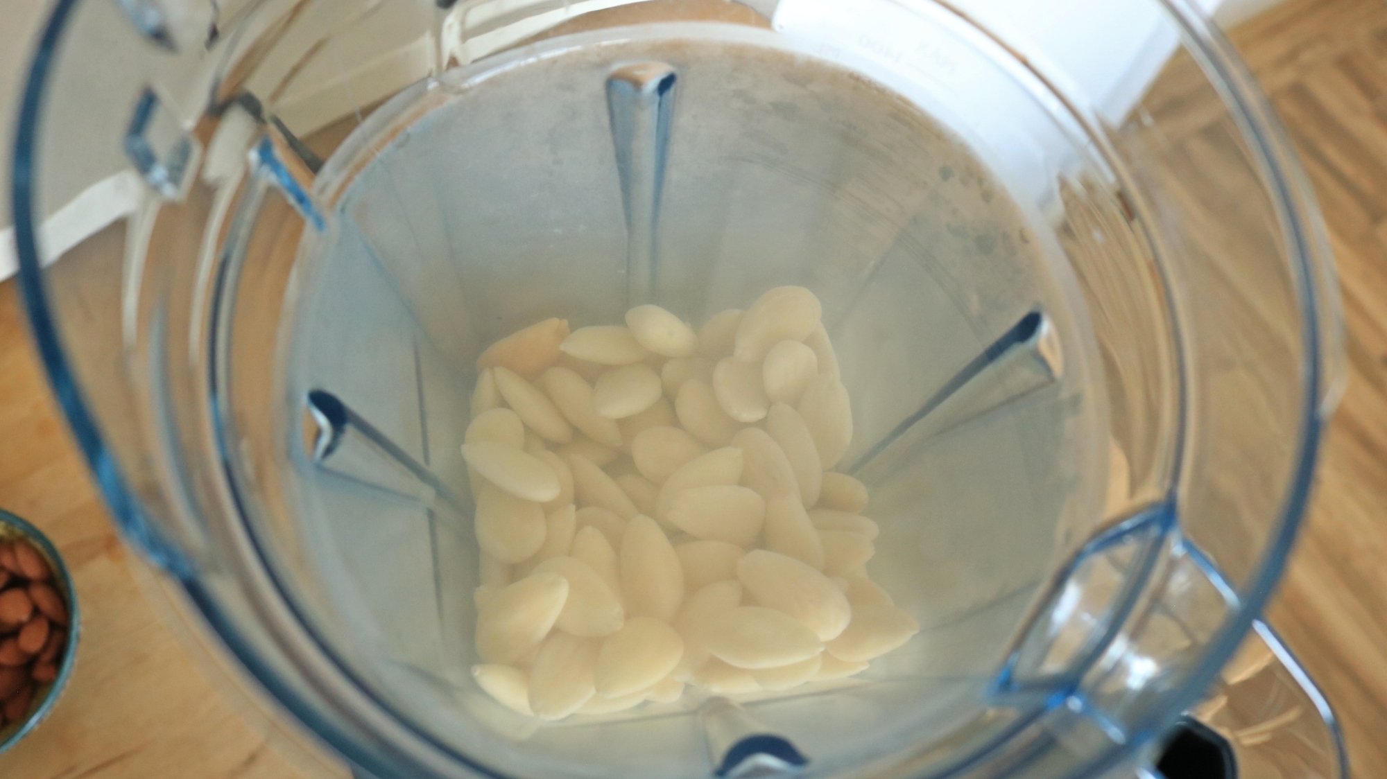 Almonds in a blender container with cold water.